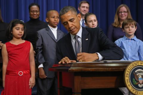 President Obama signs executive orders on new gun law proposals with children. Chip Somodevilla/Getty Images Chip Somodevilla/Getty Images