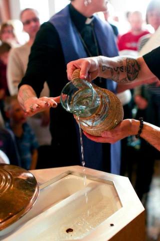 The hands of the author and ordainee, Matthew Nickoloff, in the baptismal font. Photo via the author. The hands of the author and ordainee, Matthew Nickoloff, in the baptismal font.