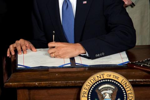 President Barack Obama signs the health insurance reform bill, March 23, 2010. Photo via RNS. President Barack Obama signs the health insurance reform bill, March 23, 2010. P