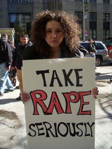 Protester holding placard, 2010. Image via Wylio. http://bit.ly/rXM1Om Protester holding placard, 2010. Image via Wylio. http://bit.ly/rXM1Om