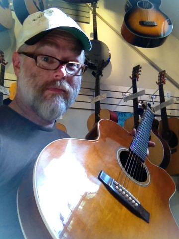 The author and the object of his affection: the seven-string guitar. Image courtesy of Tripp Hudgins. The author and the object of his affection: the seven-string guitar.
