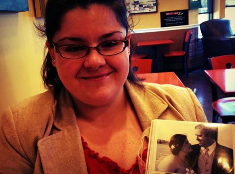 Amanda Holowaty holds a photo of she and her husband Mike Holowaty on their wedding day in May 2012. Photo courtesy RNS.