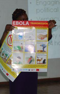 The Rev. Pauline Njiru, of Kenya displays a poster showing how Ebola can be transmitted. Photo via Fredrick Nzwili / RNS The Rev. Pauline Njiru, of Kenya displays a poster showing how Ebola can be tran