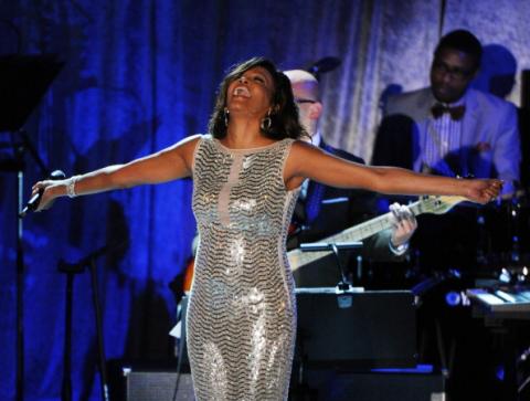 Whitney Houston sings at a 2011 pre-Grammy Awards event. Photo via Getty Images.
