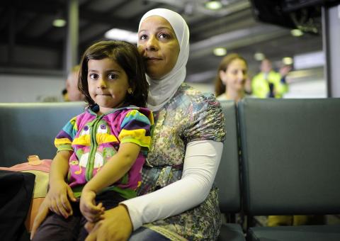 Syrian Refugees sit in the arrival hall after arriving at Hanover Airport on Sept. 11 in Germany. Alexander Koerner/Getty Image Alexander Koerner/Getty Images