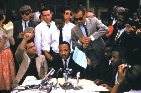 The Rev. Martin Luther King Jr., surrounded by supporters at a rally in Birmingham, 1962. Photo by Ernst Haas/Getty Images. 1962. Photo by Ernst Haas/Getty Images.