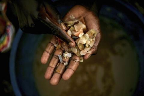 Boy sorts through minerals looking for gold at a mine in Congo, 2006. Photo by Spencer Platt/Getty Images. Photo by Spencer Platt/Getty Images