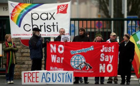 Peace activists support Iraq war veteran and now conscientious objector Agustin Aguayo. Photo by Getty Images. Conscientious objectors rally in Germany. Image via Getty Images.