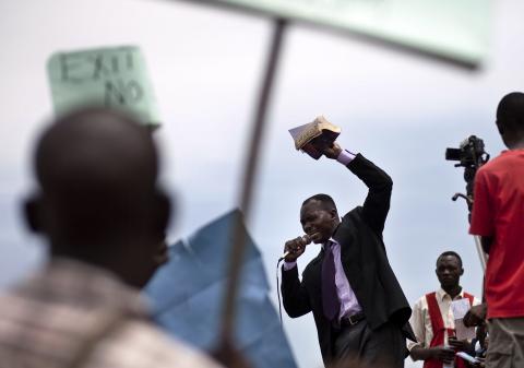Man holding Bible speaks during anti-homosexuality rally in Kamapala, Uganda 2/14/10. Photo by AFP/Getty Images. Man holding Bible speaks during anti-homosexuality rally in Kamapala, Uganda