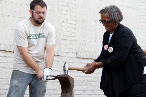 A mother who lost her child to gun violence beats on the barrel of a handgun from the streets. Photo courtesy of Shane Claiborne Photo courtesy of Shane Claiborne
