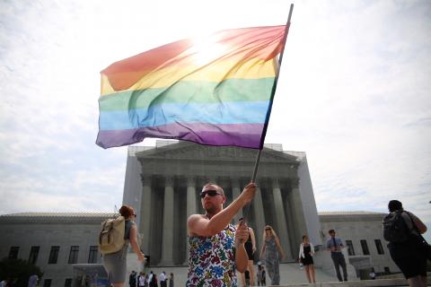 A supporter of same-sex marriage stands in front of the Supreme Court Monday. Photo via Brandon Hook/Sojourners.