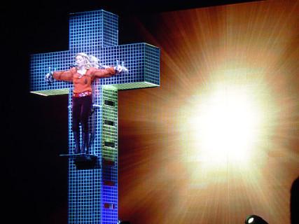 Madonna in her Confessions Tour, hanging from a mirrored cross in 2006. Photo: RNS/courtesy Oscar Rohena via Wikimedia Commons