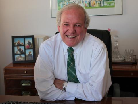Mike McCurry sits at his desk. Kara Lofton/Sojourners Kara Lofton/Sojourners