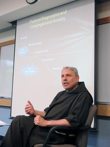Rev. David Couturier explains principles of what he calls “Franciscan economics” to priests-in-training. RNS photo: David Gibson