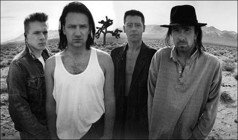 U2 album photo from The Joshua Tree by Anton Corbijn with the Joshua tree in the background. U2 album photo from The Joshua Tree by Anton Corbijn