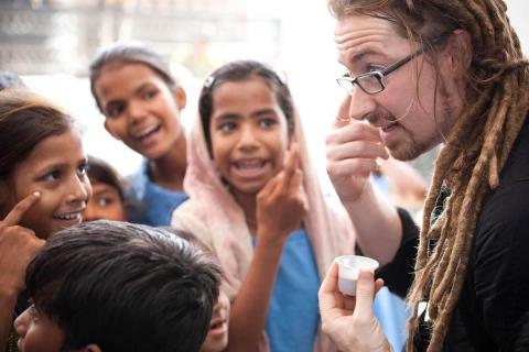 The author visits with children in India, 2010. Image via Facebook. The author visits with children in India, 2010. Image via Facebook.