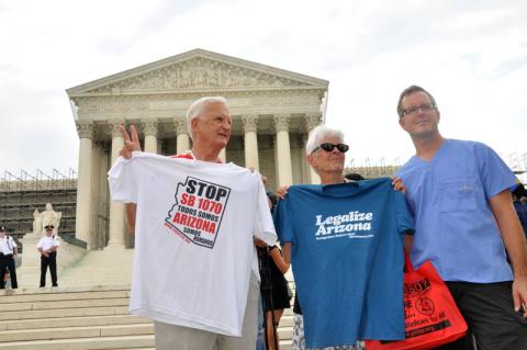 Opponents of SB 1070 stand outside the Supreme Court as the decision is handed down. Ivone Guillen / Sojourners Ivone Guillen / Sojourners
