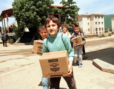 Refugees carry USAID packages, Northfoto / Shutterstock.com Refugees carry USAID packages, Northfoto / Shutterstock.com