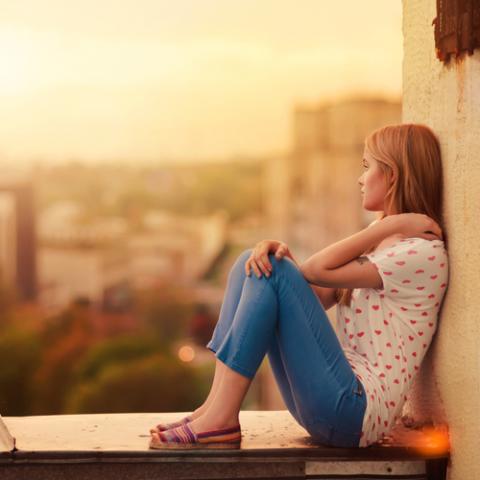 Blonde sitting on the roof of the house. Aleshyn_Andrei / Shutterstock Aleshyn_Andrei / Shutterstock