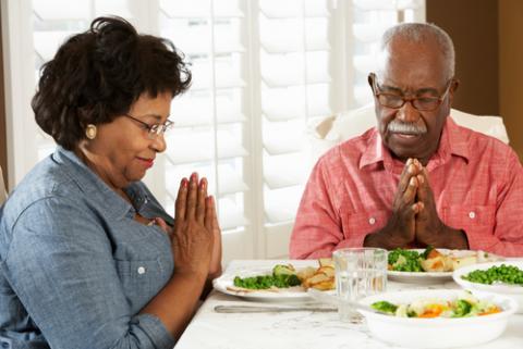 Couple praying at mealtime, Monkey Business Images / Shutterstock.com Couple praying at mealtime, Monkey Business Images / Shutterstock.com