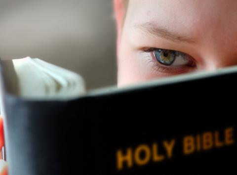 10-11 years boy reading the holy bible. Mikael Damkier / Shutterstock Mikael Damkier / Shutterstock