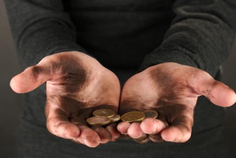 Man holding coins, close-up of his hands. Photo courtesy Africa Studio/Shutterstock.com. Photo courtesy Africa Studio/Shutterstock.com.
