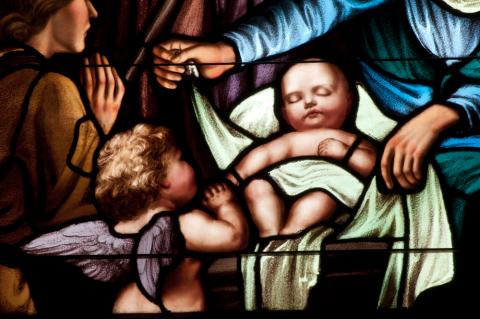 Details of stained glass window depicting baby Jesus at Christmas. Nancy Bauer / Shutterstock