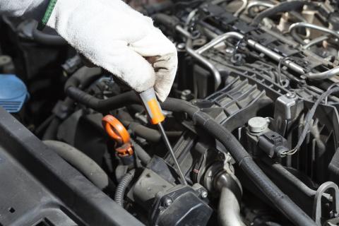 Mechanic performing the maintenance of a motor vehicle. Photo via Shutterstock/fotoedu