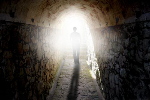 A figure walks towards the light. Photo courtesy BEELDPHOTO / shutterstock.com Photo courtesy BEELDPHOTO / shutterstock.com