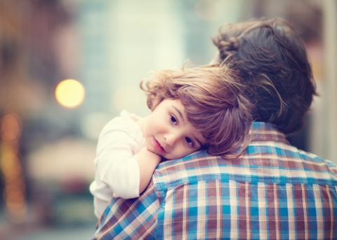 Little girl resting on her father's shoulder. Photo via Dina Uretski/Shutterstock.