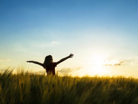 Teenage girl enjoy with sunshine in wheat field. Via oksik/Shutterstock.