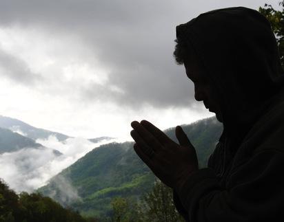 A figure prays while a storm rolls in. Image courtesy Waddell Images/shutterstock.com A figure prays while a storm rolls in. Image courtesy Waddell Images/shutterstoc