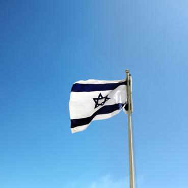Israel flag against a blue sky. Photo courtesy majeczka via Shutterstock/RNS
