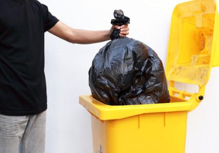 Image: Taking out the trash. Photo courtesy of Rissy Story via Shutterstock