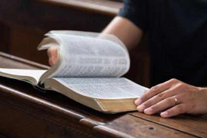 A man reading the Bible in church. Photo courtesy of Magdalena Kucova via Shutterstock
