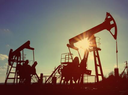 Two working oil pumps are silhouetted against the sky. Photo via Kokhanchikov / Shutterstock / RNS Photo via Kokhanchikov / Shutterstock / RNS