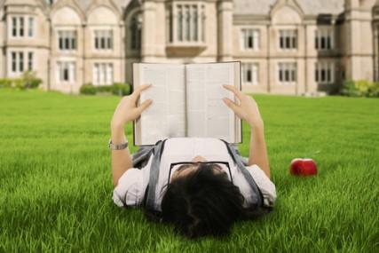 A female college student reads a book. Image courtesy Creativa/shutterstock.com A female college student reads a book. Image courtesy Creativa/shutterstock.com