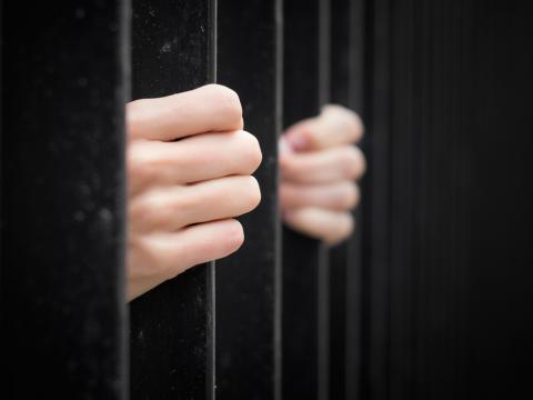 Hands on prison bars. Image courtesy Kaspars Grinvalds/shutterstock.com Hands on prison bars. Image courtesy Kaspars Grinvalds/shutterstock.com