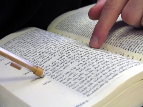 Student pointing at bible, Nir Levy/Shutterstock.com. Student pointing at bible, Nir Levy/Shutterstock.com.