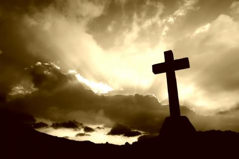 Cross detail in silhouette and the clouds in the sky. rui vale sousa / Shutterstock rui vale sousa / Shutterstock