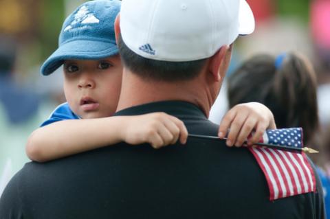 Nelson Navidad holds his son at a 2009 immigration rally. RyanRoderickBeiler.com / Shutterstock.com Nelson Navidad holds his son at a 2009 immigration rally. RyanRoderickBeiler.c /