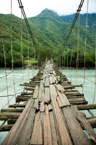 Rickety bridge over rapids. Image via Zastolskiy Victor/shutterstock.com Rickety bridge over rapids. Image via Zastolskiy Victor/shutterstock.com