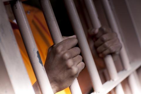 Hands behind bars, Dan Bannister / Shutterstock.com Hands behind bars, Dan Bannister / Shutterstock.com