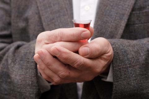 Man holding a communion cup. Suzanne Tucker / Shutterstock.com Suzanne Tucker / Shutterstock.com