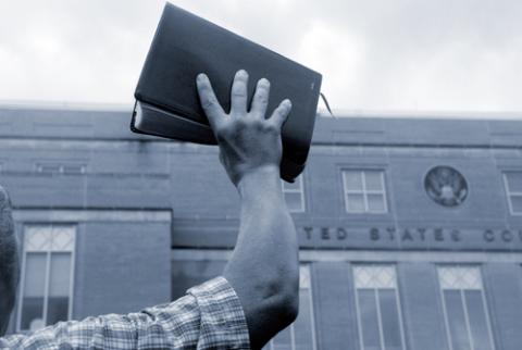 Man holding up Bible in front of court house, Cheryl Casey / Shutterstock.com Man holding up Bible in front of court house, Cheryl Casey / Shutterstock.com