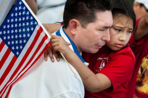 Father and child at an immigration march in Washington, D.C. By Ryan Rodrick Beiler for Shutterstock. By Ryan Rodrick Beiler for Shutterstock.