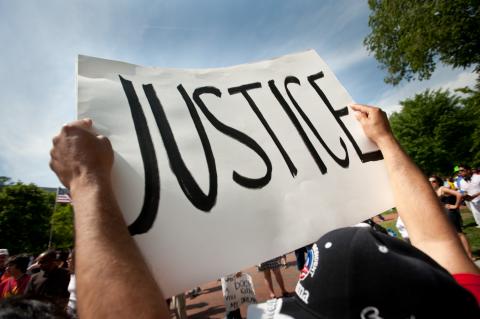 An immigration reform activist holds a sign reading "Justice." Ryan Rodrick Beiler / Shutterstock.com Ryan Rodrick Beiler / Shutterstock.com