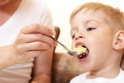 Mother feeding her son at home. Marina Dyakonova / Shutterstock Marina Dyakonova / Shutterstock