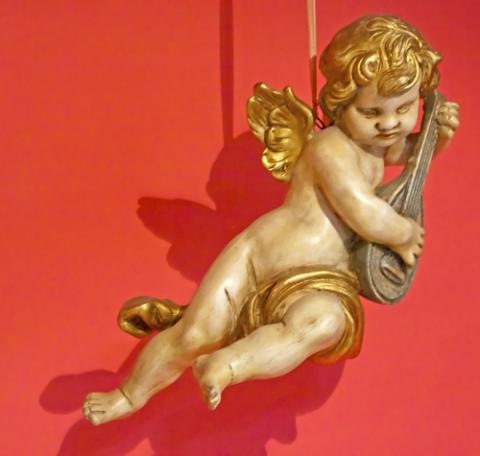 Statue of a young angel playing the mandolin. Photo courtesy Fabio Alcini/shutterstock.com