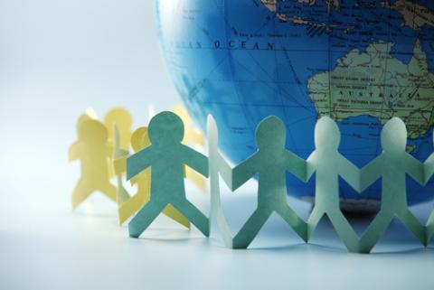 Paper chain surrounding the globe. discpicture / Shutterstock discpicture / Shutterstock